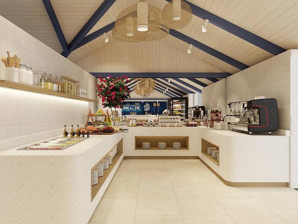 Area buffet del ristorante a Eri Maldives con bancone chiaro a U, macchina per il caffè, vassoi di pietanze e soffitto a falde con travi blu