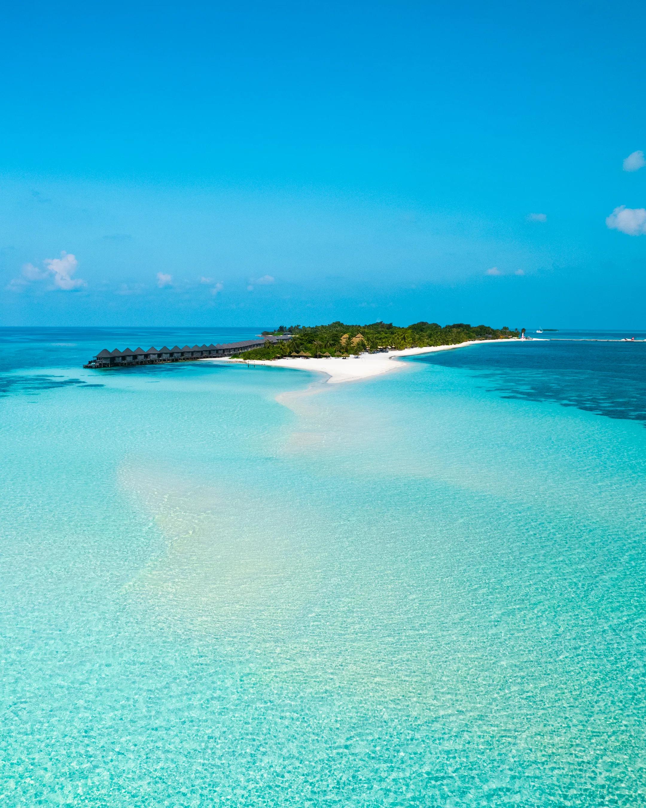 Spiaggia con sabbia bianca e bungalow sul mare al Kuredu Island Resort & Spa.