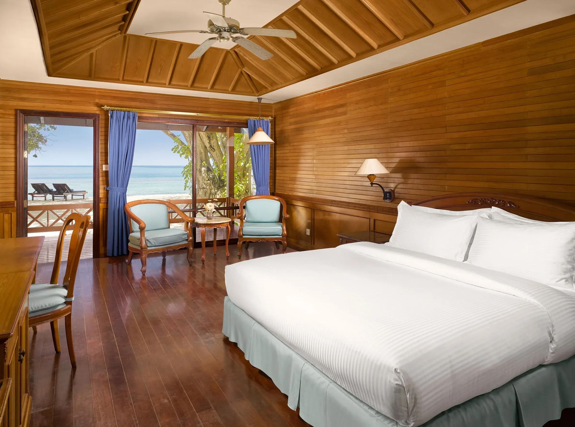 Beach Villa con letto matrimoniale e finestre con vista mare al Royal Island Resort & Spa