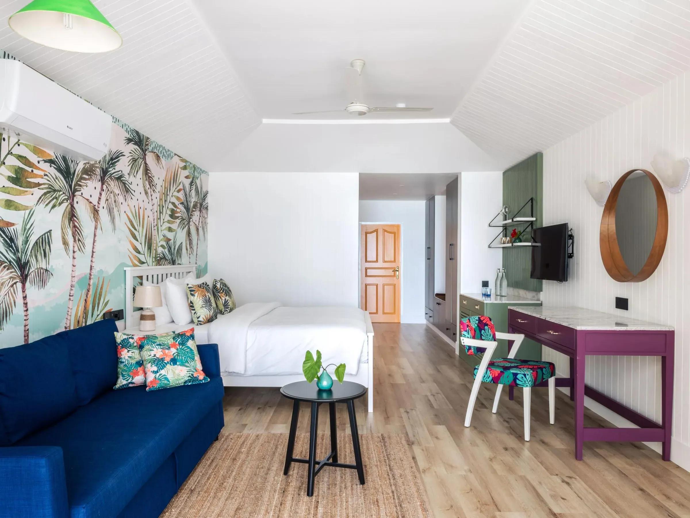 Camera Lagoon Beach Pool Villa con letto, divano blu e scrivania al Villa Park Sun Island Resort & Spa
